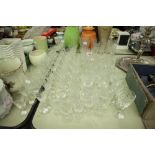 QUANTITY OF ETCHED AND CUT GLASS - DRINKING GLASSES, CHAMPAGNE FLUTES ETC....