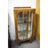 A SMALL CARVED OAK CHINA DISPLAY CABINET ON TURNED SUPPORTS TO SLEDGE FEET