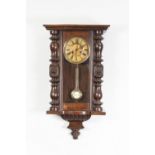 AN EARLY TWENTIETH CENTURY SPRING DRIVEN WALL CLOCK (LACKS CREST) AND AN ANTIQUE WHEEL BAROMETER