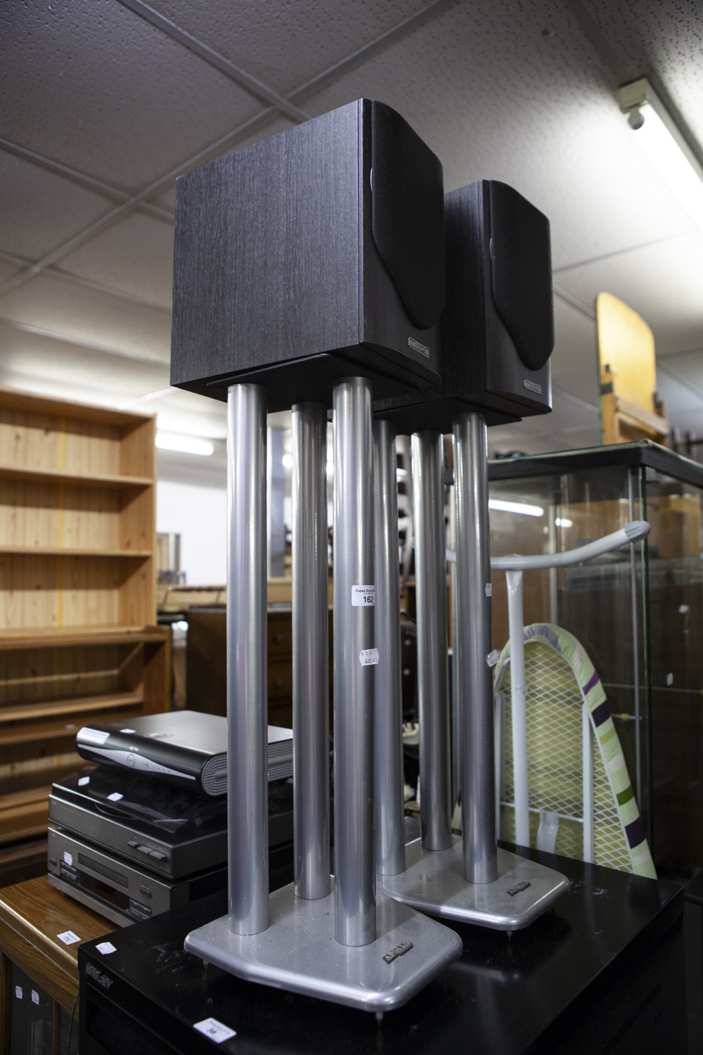 AN IRONING BOARD, PAIR OF MISSION SPEAKERS, ON STAND, A MODERN MAGAZINE RACK AND A BLACK 3-TIER TV