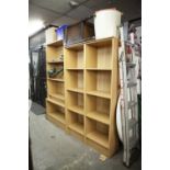 A TWO DIVISION LIGHT FINISH OPEN BOOKCASE OF FOUR TIERS AND A SIMILAR BUT TALLER OPEN BOOKCASE