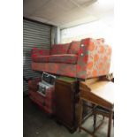A MODERN THREE SEATER SETTEE AND MATCHING ARMCHAIR IN RED IN GREY FLORAL PATTERN