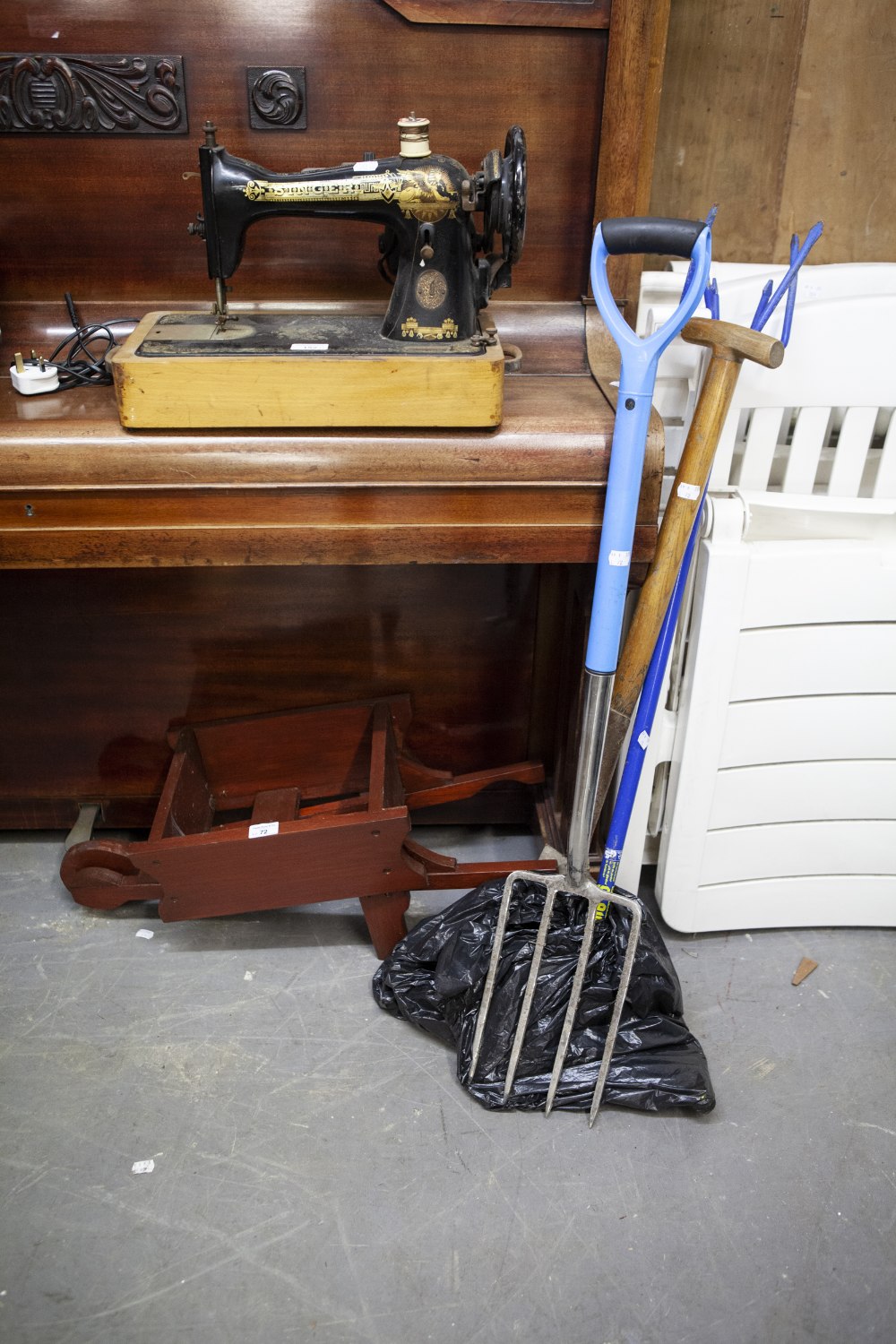 A SMALL WOODEN WHEELBARROW AND GARDEN TOOLS (4)