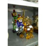TWO COLOURED GLASS FIGURES OF CLOWNS AND A PINK GLASS ELEPHANT ORNAMENT (3)