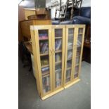 A PAIR OF MODERN TALL CUPBOARDS WITH FROSTED GLASS PANELS AND A QUANTITY OF CD's AND DVD'S