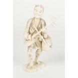 A JAPANESE MEIJI PERIOD CARVED SECTIONAL IVORY FIGURE holding a stringed musical instrument and