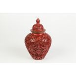 A TWENTIETH CENTURY CHINESE CINABAR LACQUER JAR WITH COVER, carved autour with lotus, foliate