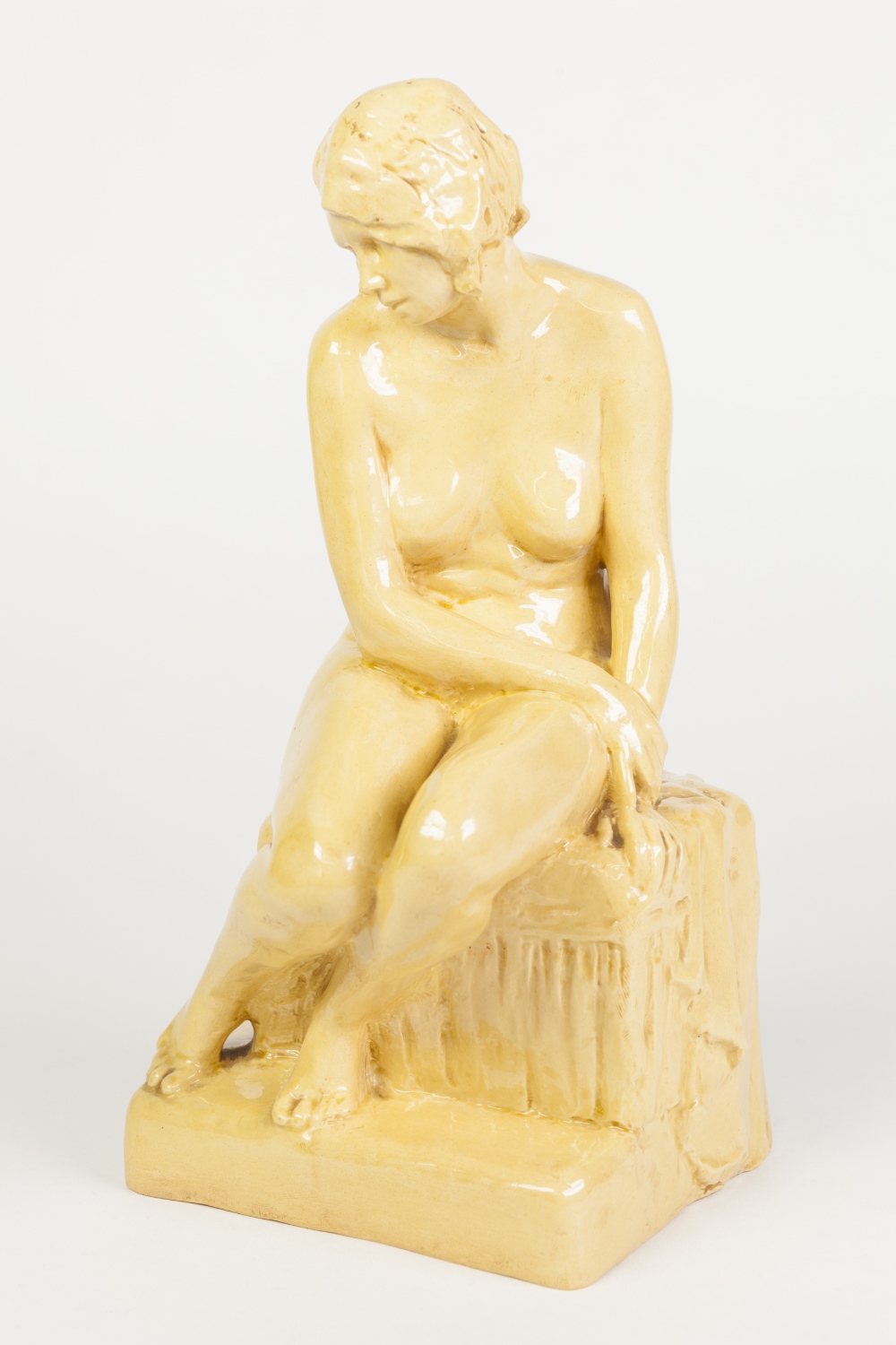 ART DECO POTTERY LADY FIGURINE, the seated nude figure with down turned head and arm draped over her