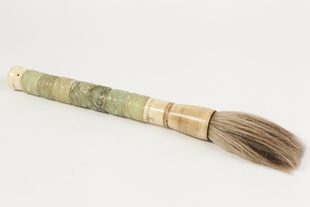 A CHINESE LARGE CARVED GREEN STONE AND MARINE IVORY BRUSH, the handle terminating in suspension