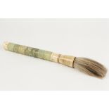 A CHINESE LARGE CARVED GREEN STONE AND MARINE IVORY BRUSH, the handle terminating in suspension