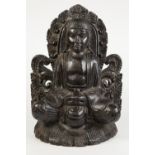 NINETEENTH CENTURY ORIENTAL CARVED AND EBONISED SOFTWOOD FLAT BACKED FIGURE OF BUDDHA, seated