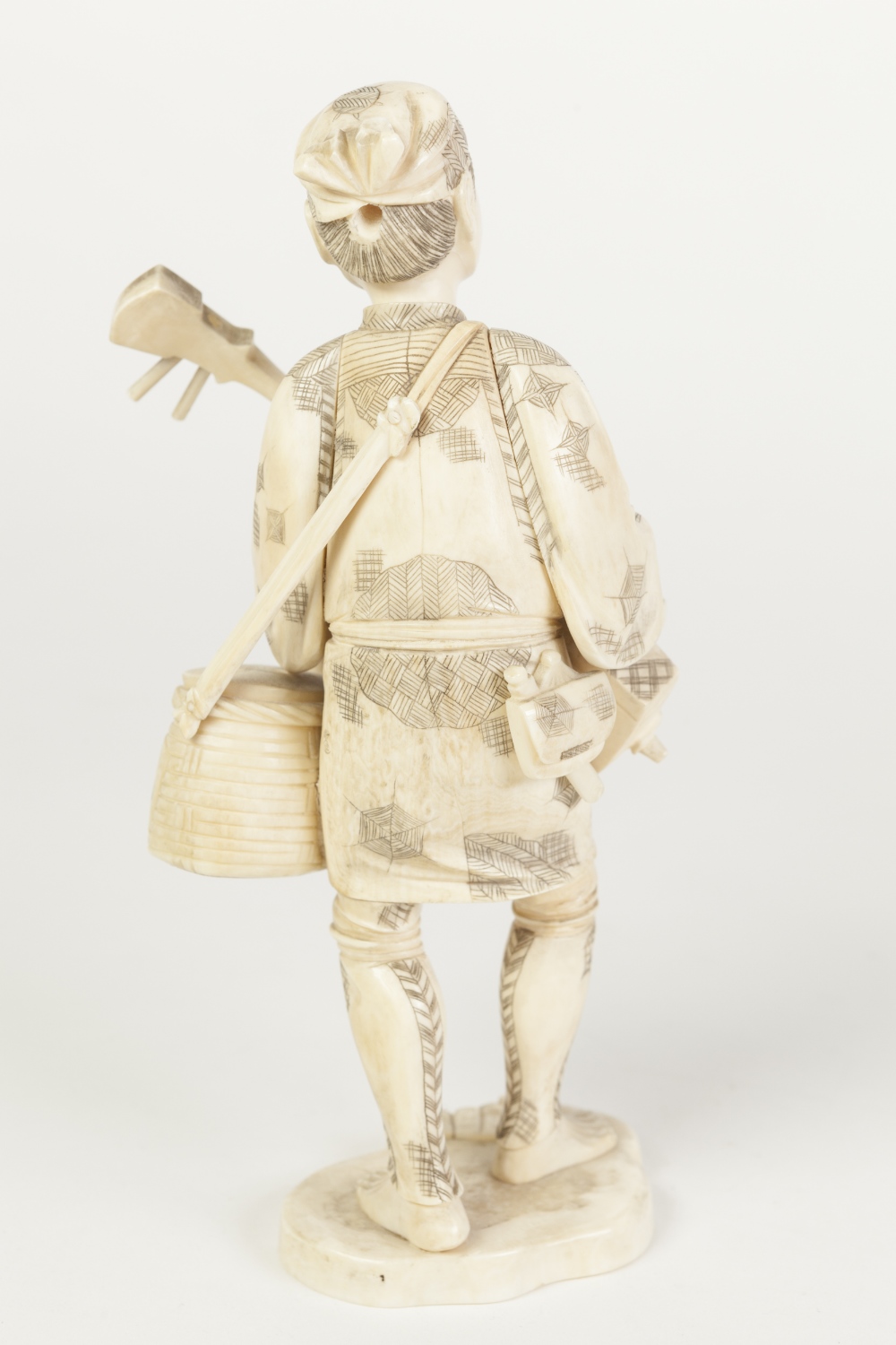 A JAPANESE MEIJI PERIOD CARVED SECTIONAL IVORY FIGURE holding a stringed musical instrument and - Image 2 of 3