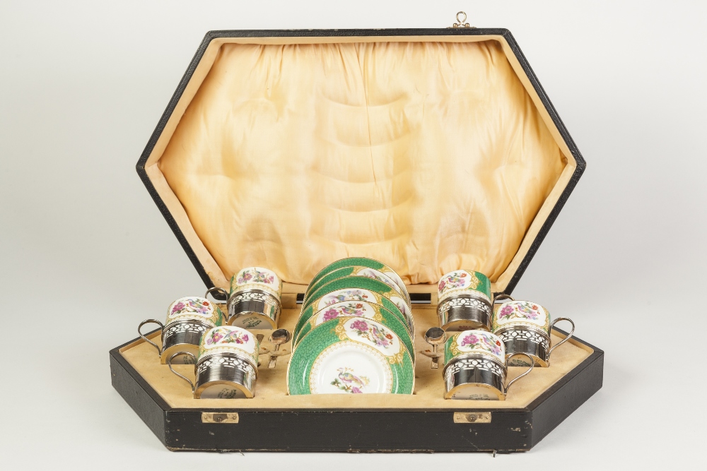 AN EARLY TWENTIETH CENTURY CASED GROSVENOR CHINA COFFEE SERVICE with silver cup holders and