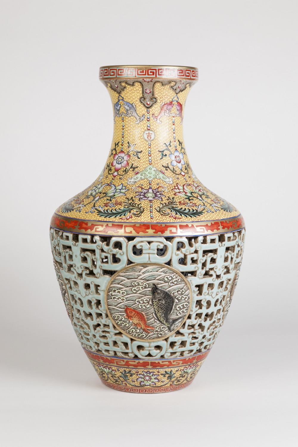 A FINE CHINESE PORCELAIN DOUBLE WALLED RETICULATED VASE, THE OVOID BODY PIERCED WITH PALE BLUE