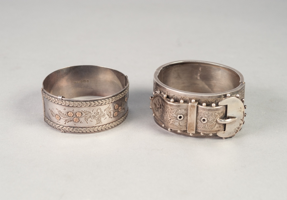 VICTORIAN SILVER BROAD HINGE OPENING BANGLE, the engraved top having applied strap and buckle