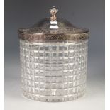 AN EDWARDIAN CUT GLASS BISCUIT BARREL with electroplated cover and rim mount