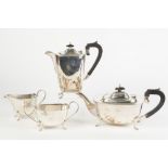 A PRE-WAR SILVER FOUR PIECE TEA AND COFFEE SERVICE, of rounded oblong shape, each standing on four