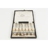 A LATER CASED SET OF SIX VICTORIAN SILVER TEASPOONS, with openwork handles and scallop bowls,