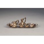 SILVER COLOURED METAL MINIATURE TEA AND COFFEE SERVICE OF 4 PIECES, of George III semi lobed oval