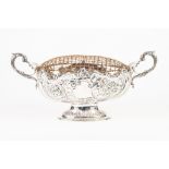 VICTORIAN SILVER TWO HANDLED OVAL PEDESTAL BOWL, with rococo scroll embossed and shaped border,