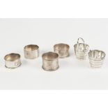 FOUR ODD SILVER NAPKIN RINGS, ALSO A PAIR OF PROBABLY CHINESE EARLY 1900's SILVER MINIATURE