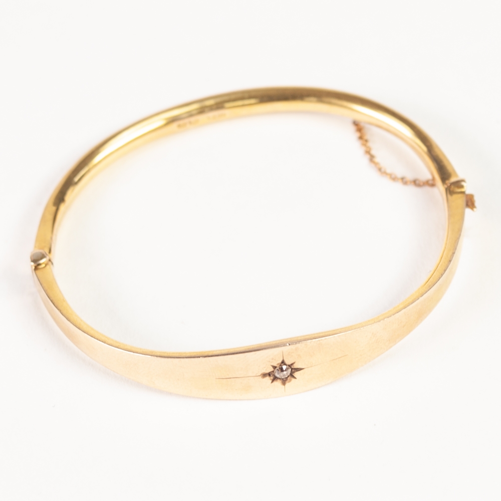 PROBABLY VICTORIAN 9ct GOLD HOLLOW BANGLE, hinge opening, the swelling top star set with a tiny