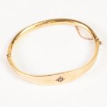 PROBABLY VICTORIAN 9ct GOLD HOLLOW BANGLE, hinge opening, the swelling top star set with a tiny