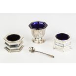 AN EARLY VICTORIAN SILVER OCTAGONAL PEDESTAL SALT CELLAR with blue glass liner, the tapered body