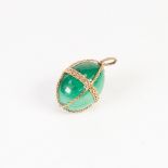 A CAPTIVE MALACHITE 'EGG' within a gold coloured metal woven girdle and two gold coloured metal rope