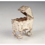 LATE NINETEENTH CENTURY CONTINENTAL SILVER MINIATURE CRIB with hood and lateral rockers, the whole