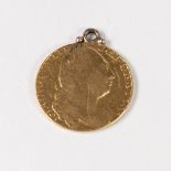A GEORGE III GOLD GUINEA (worn and soldered suspension loop) 8.4gms