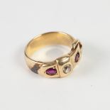 VICTORIAN GOLD (UNMARKED) BUCKLE RING, set with an old cut diamond and two rubies, 10.8gms, the