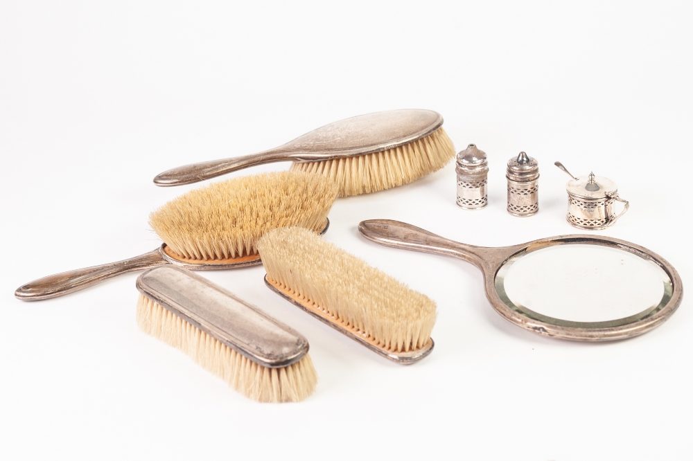 A CASED SILVER CONDIMENT SET, Birmingham 1931, also a FIVE PIECE SILVER BACKED DRESSING TABLE