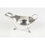 A TWENTIETH CENTURY SILVER SAUCE BOAT with ring handle, on three pad feet, Sheffield 1944, 8oz