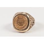 9ct GOLD SIGNET RING, WITH BARK TEXTURED SHOULDERS, the top set with a 1945 gold 'Dos Pesos' small