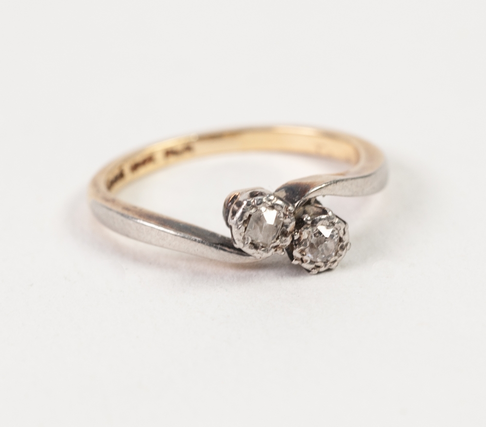 18ct GOLD AND PLATINUM CROSS OVER RING, set with two old cut diamonds in deceptive settings,