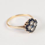 18ct, DIAMOND AND SAPPHIRE QUATREFOIL CLUSTER RING, set with a small centre sapphire with surround