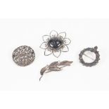SCOTTISH SILVER OPENWORK FLOWER BROOCH, set with a large circular cabochon hardstone, 2" diameter,
