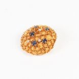 18ct GOLD, DIAMOND AND SAPPHIRE BROOCH, circular and domed with fine bead textured surface and low