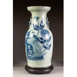 CHINESE BLUE AND WHITE PORCELAIN VASE, of Indian club form with moulded dog of fo to the waisted