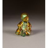 ZSOLNEY PECS, HUNGARIAN LUSTRE GLAZED POTTERY FIGURE OF A SEATED CHILD, 2 ¾" (7cm) high, printed