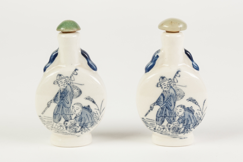 TWO IDENTICAL MODERN CHINESE POTTERY SNUFF BOTTLES, decorated with figures in blue