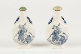 TWO IDENTICAL MODERN CHINESE POTTERY SNUFF BOTTLES, decorated with figures in blue