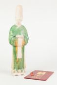 A CHINESE POSSIBLY MING DYNASTY PARTIALLY GREEN SHADING TO YELLOW GLAZED BISCUIT POTTERY FIGURE,