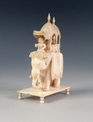 EARLY TWENTIETH CENTURY INDIAN CARVED IVORY GROUP OF FIGURES IN A HOWDAH ON A CEREMONIAL ELEPHANT,