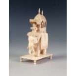 EARLY TWENTIETH CENTURY INDIAN CARVED IVORY GROUP OF FIGURES IN A HOWDAH ON A CEREMONIAL ELEPHANT,