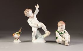 HEREND PORCELAIN FIGURE OF A CHERUB, together with A HUNGARIAN PORCELIAN FIGURE OF A SEATED CHILD