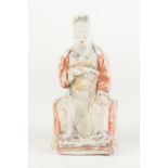 AN AGED CHINESE WHITE CHALK SURFACED TERRACOTTA BISCUIT FIGURE of an enthroned dignitary with in