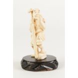 A SMALL JAPANESE MEIJI PERIOD ONE PIECE CARVED IVORY OKIMONO, of a peasant male holding an oar