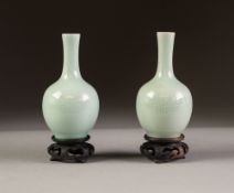 PAIR OF CHINESE CELADON GLAZED PORCELAIN SMALL VASES, each of bottle form, with carved decoration, 4